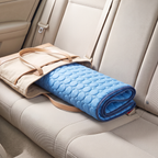 Frostnose cooling mat rolled up in a tote bag on a car seat